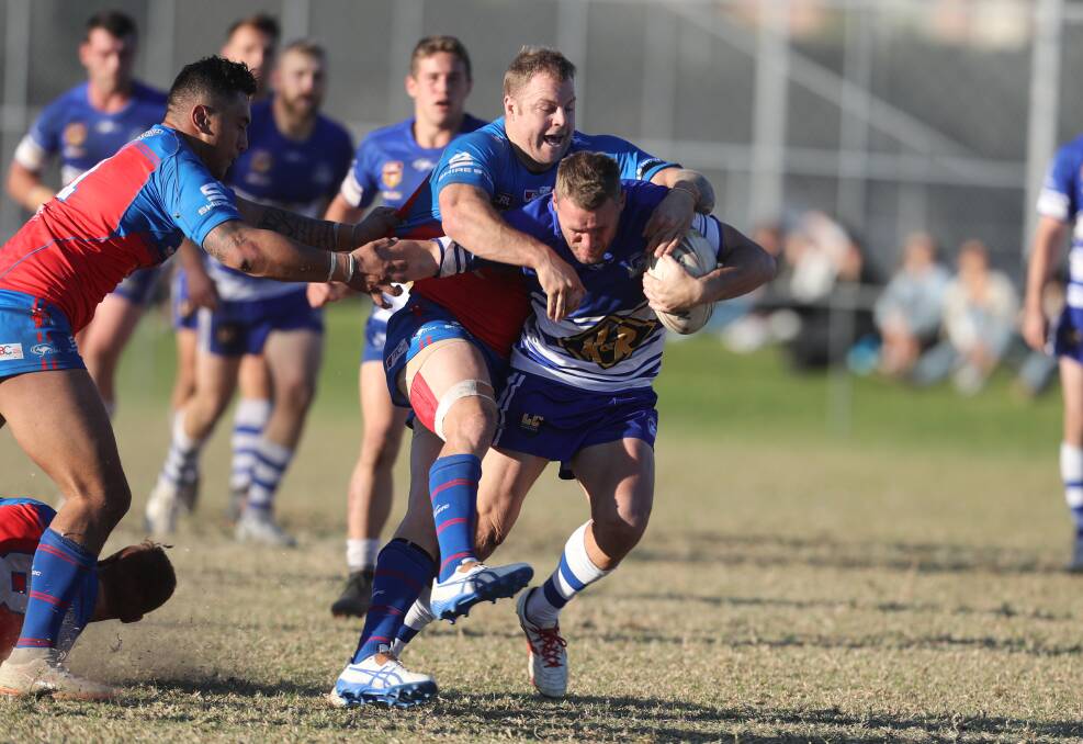 TOUGH BATTLE: Wests prop Kyle Lodge tustles with Thirroul centre Wayne Dargan in the Devils 18-4 win over the Butchers on Saturday. Picture: Robert Peet