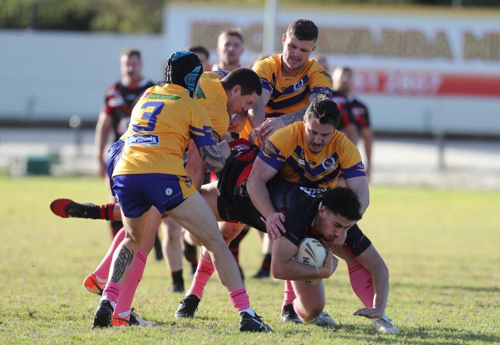 TOUGH STUFF: Dante Lusio mixes it up with the Dapto big men in the Dogs 36-16 win over the Canaries on Saturday. Picture: Robert Peet