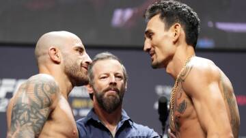 AMPED: The Alex Volkanovski-Max Holloway staredown the UFC 276 weigh-ins on Saturday. Picture: Getty Images