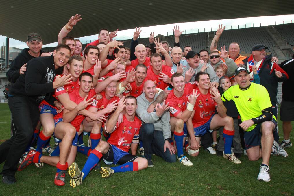 THREEPEAT: Current Dragons coach Paul McGregor (centre) celebrates the Devils third straight premiership in 2011. Picture: Ken Robertson