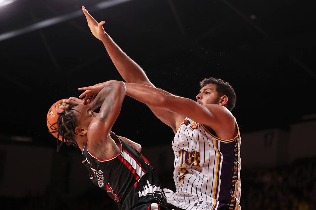 Nothing to see here? Tim Soares 'fouls' Hawks guard Justin Robinson. Picture by Getty Images