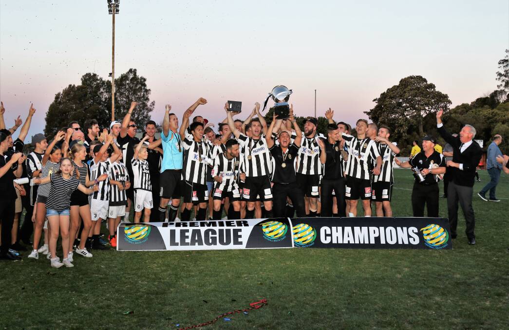 PARTY TIME: Port Kembla lift the trophy after beating League Championship winners Bulli in Sunday's Illawarra Premier League grand final. Picture: PEDRO GARCIA