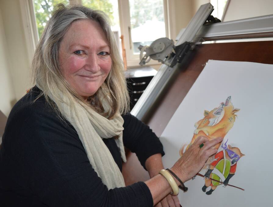 GRAND DESIGNS: Artist Cheryl Westenberg at home in Berry working on some lovable animal characters for children's book 'I Wish I Could be a Superhero' by Susan Hall. 