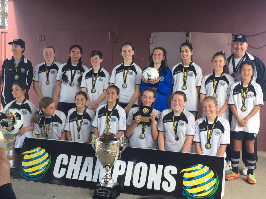 Success: Balgownie's under 13 division two girls celebrate on Sunday. 