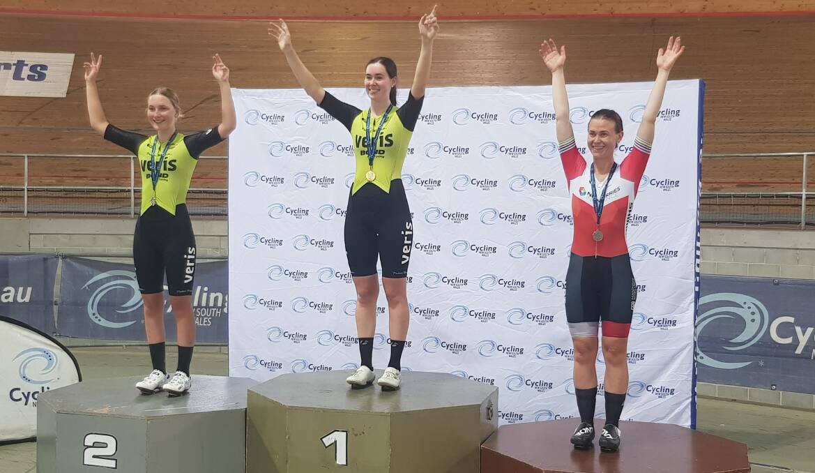 Road to success: Illawarra Cycle Club's Tahlia Dole (left, silver) and Chloe Heffernan (middle, gold) celebrate on the medal dais. 