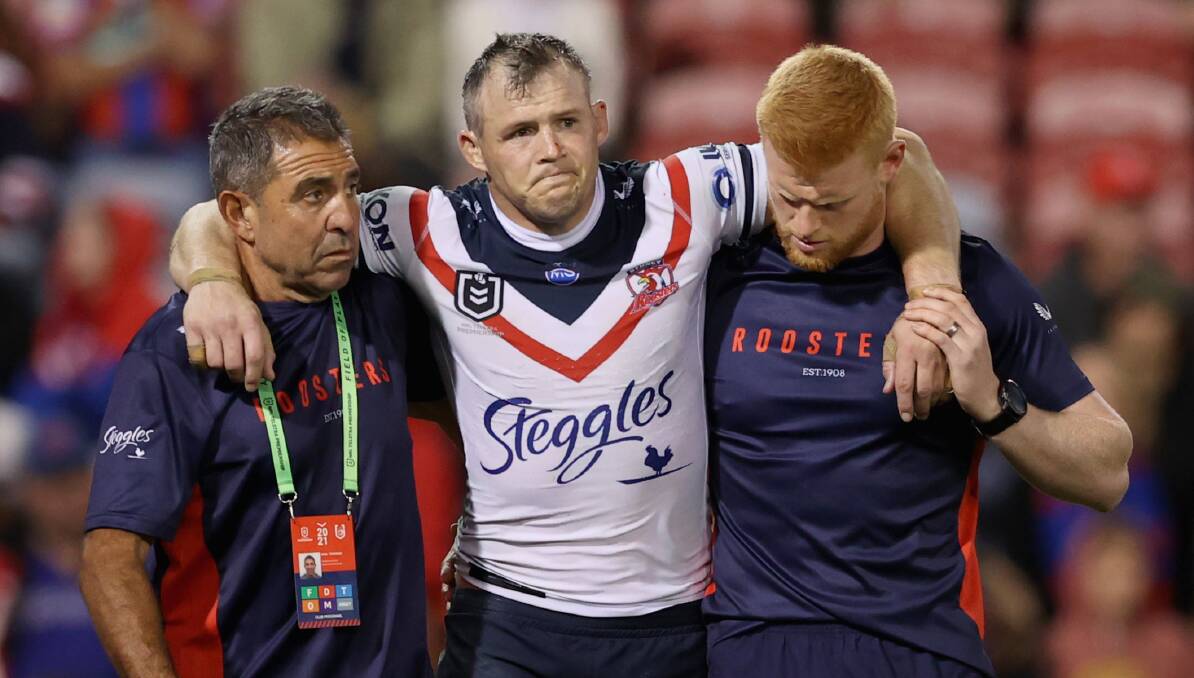 Hurt: Brett Morris is helped off the field during Saturday's win over Newcastle. Picture: Ashley Feder/Getty Images

