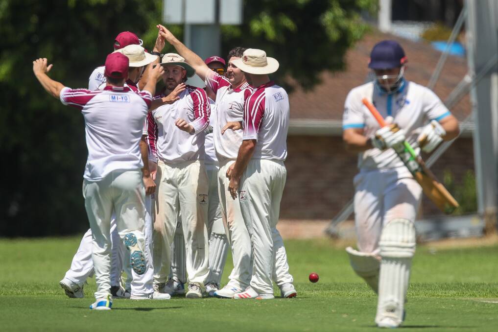 Got him: Wollongong celebrate Justin Brancato's wicket at Hollymount Park on Saturday. Picture: Adam McLean