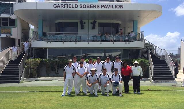 Hallowed ground: Uni's golden oldies squad in front of the Sir Garfield Sobers Pavilion at Kensington Oval last week. 