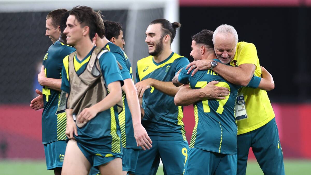 Roo beauty: Marco Tilio embraces Australian coach Graham Arnold after scoring against Argentina on Thursday night. Picture: Masashi Hara/Getty Images
