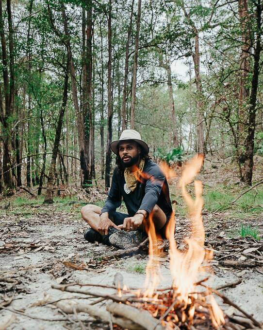Burning issue: NBA star Patty Mills during discussions over Indigenous cultural burning practices during his tour of the bushfire-ravaged South Coast. Picture: Twitter
