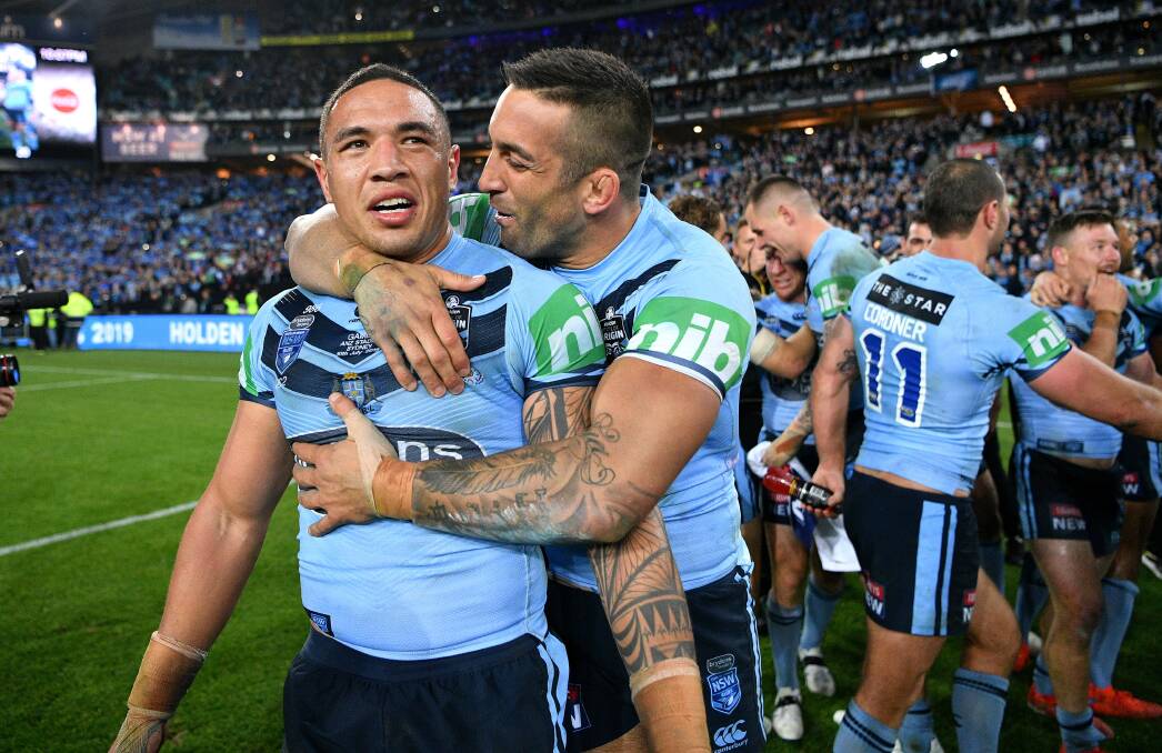 Blue beauty: Tyson Frizell and Paul Vaughan celebrate winning the State of Origin series with NSW at ANZ Stadium on Wednesday night. Picture: Gregg Porteous/NRL Imagery