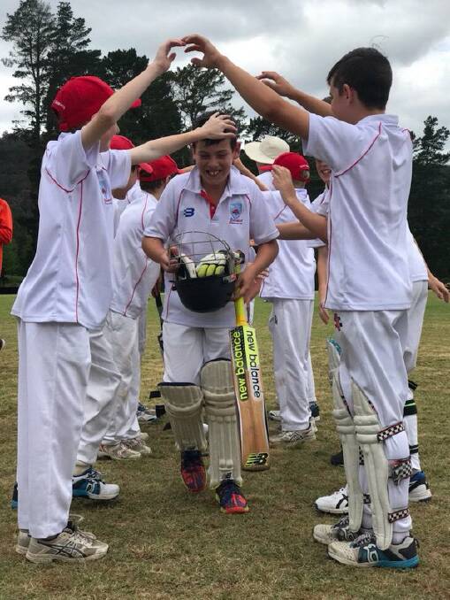 Top knock: Will Toland is congratulated on his century by Illawarra teammates at Centennial Park, Bowral on Sunday. 