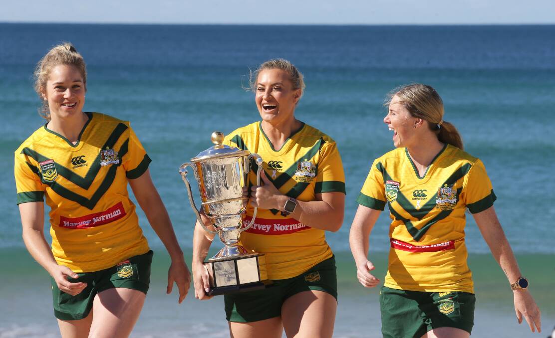 Safe hands: (From left) Jillaroos Kezie Apps, Ruan Sims and Maddie Studdon with the World Cup trophy. Picture: John Veage