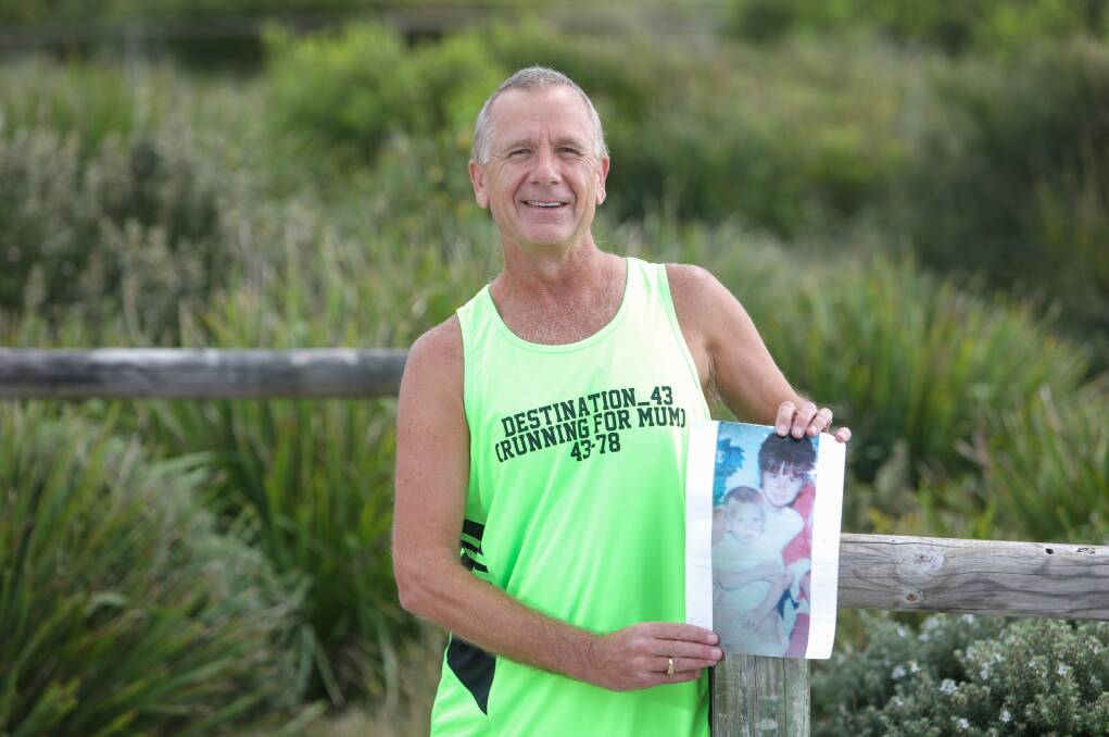 Living memory: Rick Patzold at Shellharbour beach, with a photo of his mum, before his 320th marathon. Picture: Adam McLean