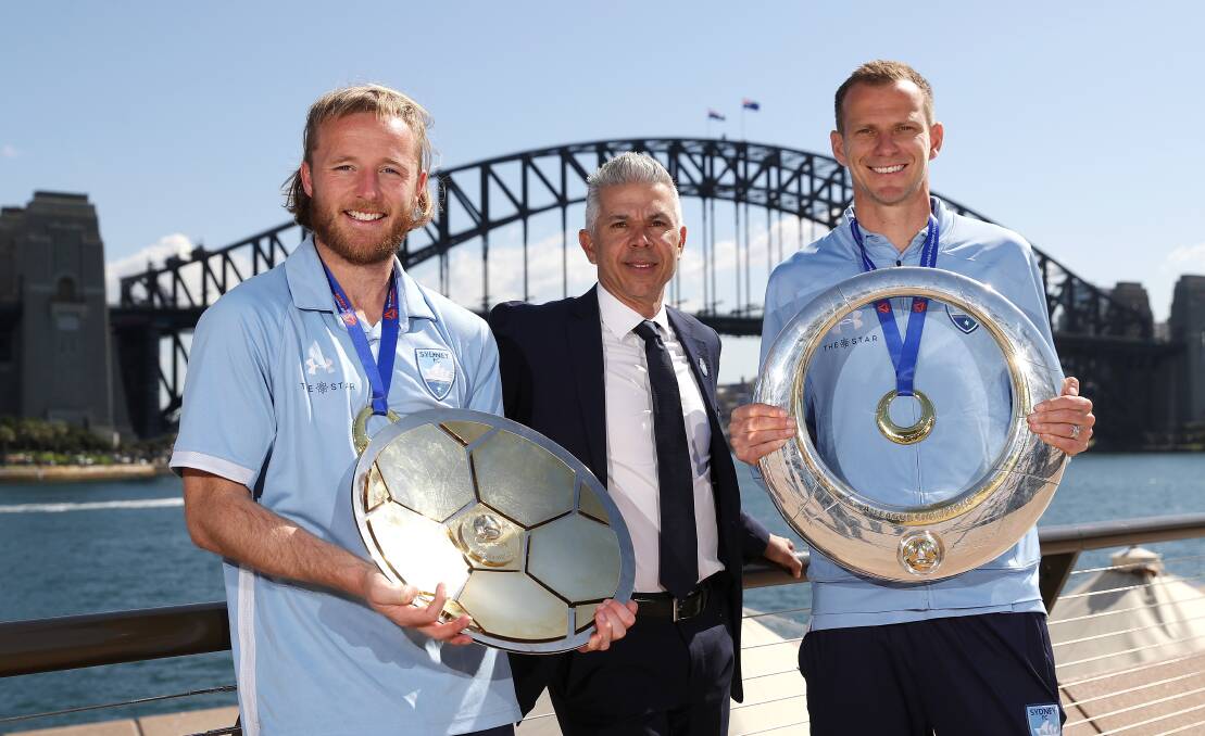 Blue skies: Rhyan Grant, Steve Corica and Alex Wilkinson with the A-League trophies on Monday. Picture: Mark Kolbe/Getty Images