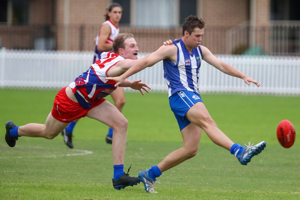 Chase: Figtree's Max Harper gets a kick away against the Bulldogs in round one. Picture: Adam McLean