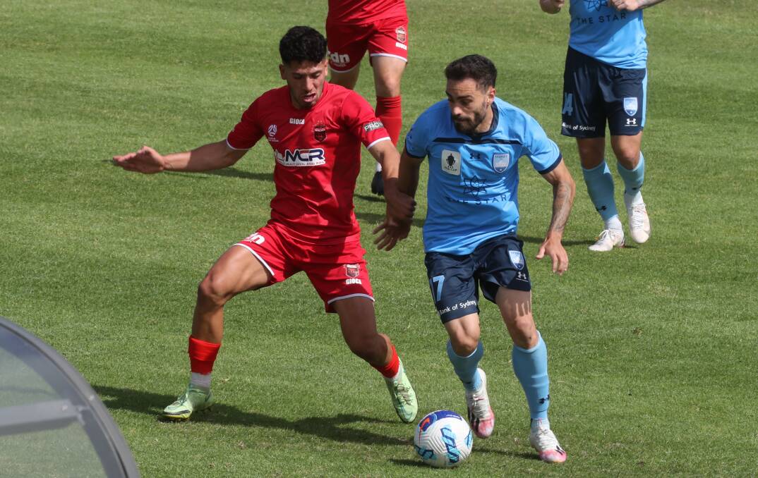 Clash: Wolves Leroy Jennings takes on Sydney FC's Antony Caceres in pre-season. Wollongong meet the Sky Blues in the NSW NPL on Friday night. Picture: Robert Peet