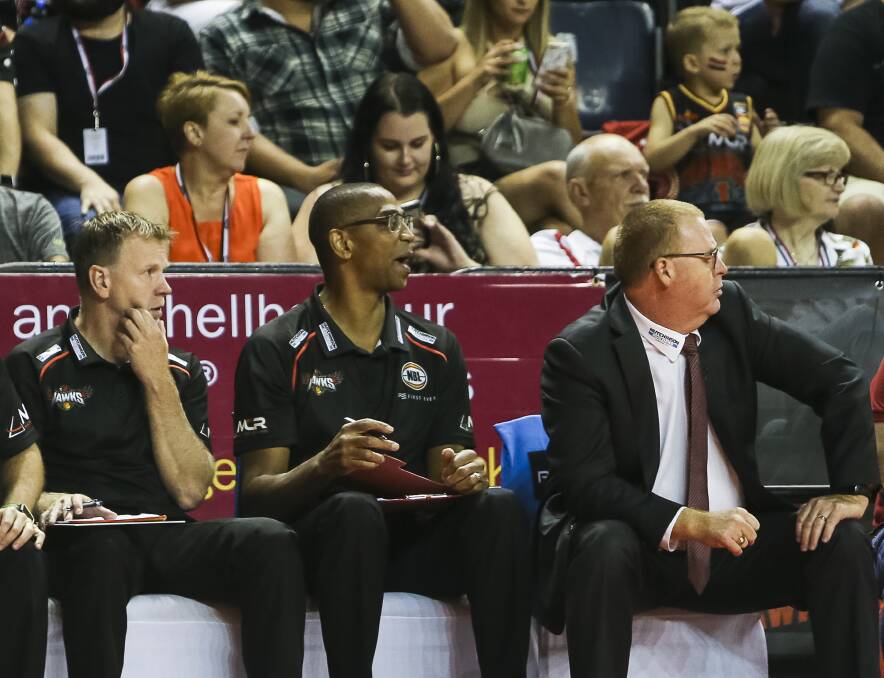 Changing places: Matt Flinn (third from left) will take over as Illawarra Hawks head coach, replacing Rob Beveridge (right). Picture: Anna Warr