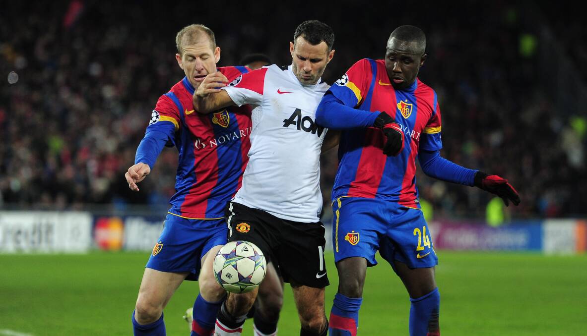 Red and blue blood: Scott Chipperfield (left) contests the ball with Manchester United's Ryan Giggs in a Champions League game in 2011. Picture: Jamie McDonald/Getty Images
