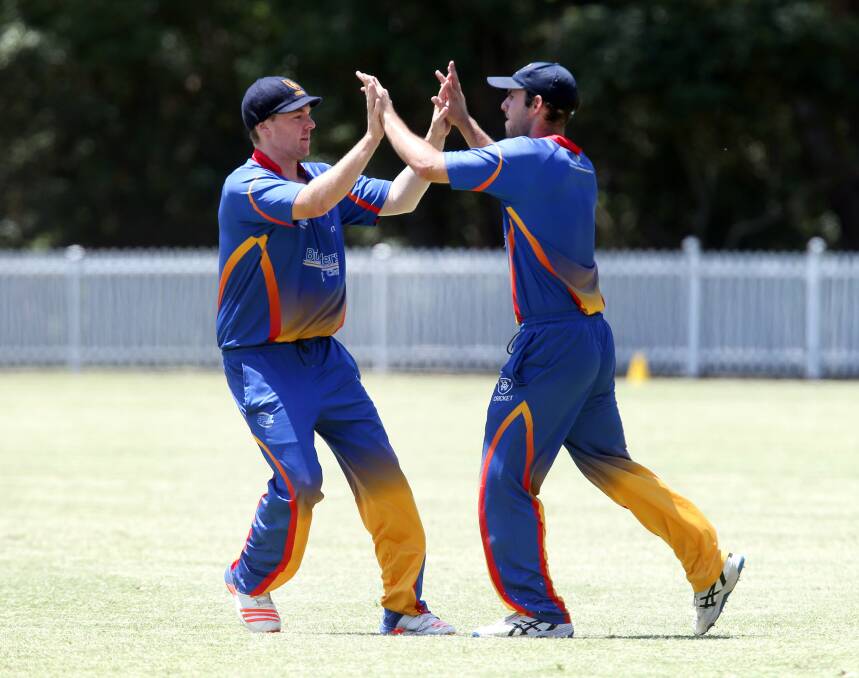 You beauty: Univerty teammates Kurt Majoor and Mitch Calder celebrate a wicket in the Twenty20 final against Wollongong .Picture: Sylvia Liber
