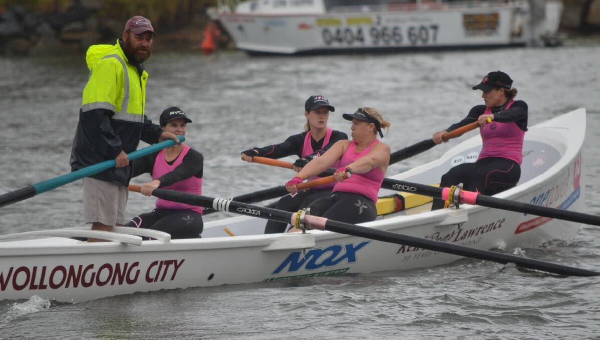 That's a paddlin: The Wollongong City women's crew, with sweep Brett Dingwall  (left) steering, negotiate the Moruya River Picture: Sam Strong
