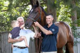 Trainers Rob and Luke Price with Rob's grandson Patrick Price, 19 months, and Cuban Royale at their Kembla Grange stables. Story: Tim Barrow