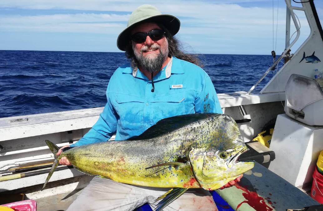 Reel it in: Peter Henderson with a sensational 134cm mahi mahi or dolphin fish.