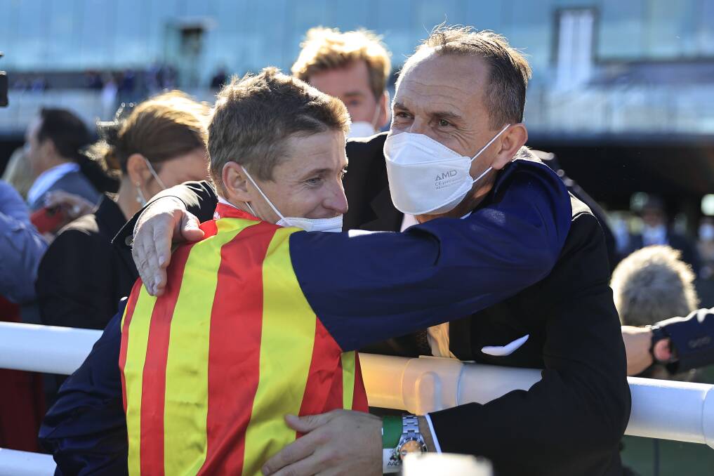 Winning ways:James McDonald hugs trainer Chris Waller after winning the Everest on Nature Strip. Picture: Mark Evans/Getty Images
