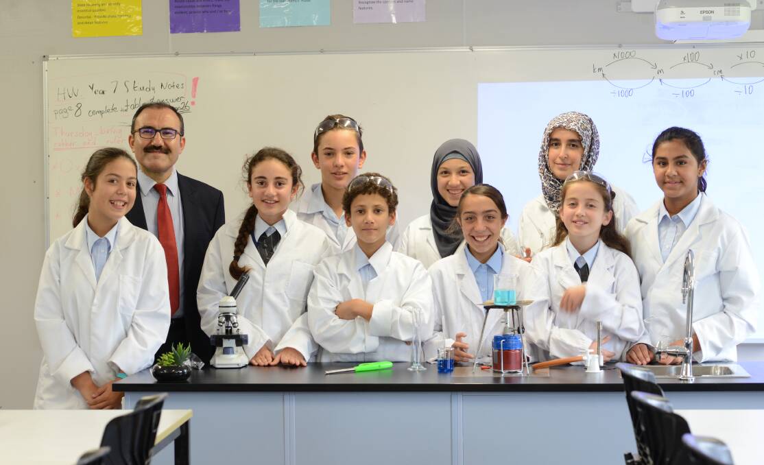 Excellence: Principal Dr Mehmet Aslan with students from Amity College Illawarra. The non-denominational private school with classes from Kindergarten to Year 8 is holding an Open Day on Saturday, March 24.