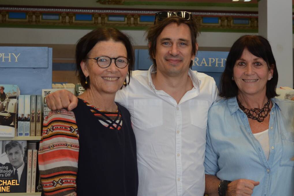 Author in store: Trent Dalton author of Boy Swallows Universe at Collins Booksellers Thirroul with owners Amanda Isler and Deborah Thompson.