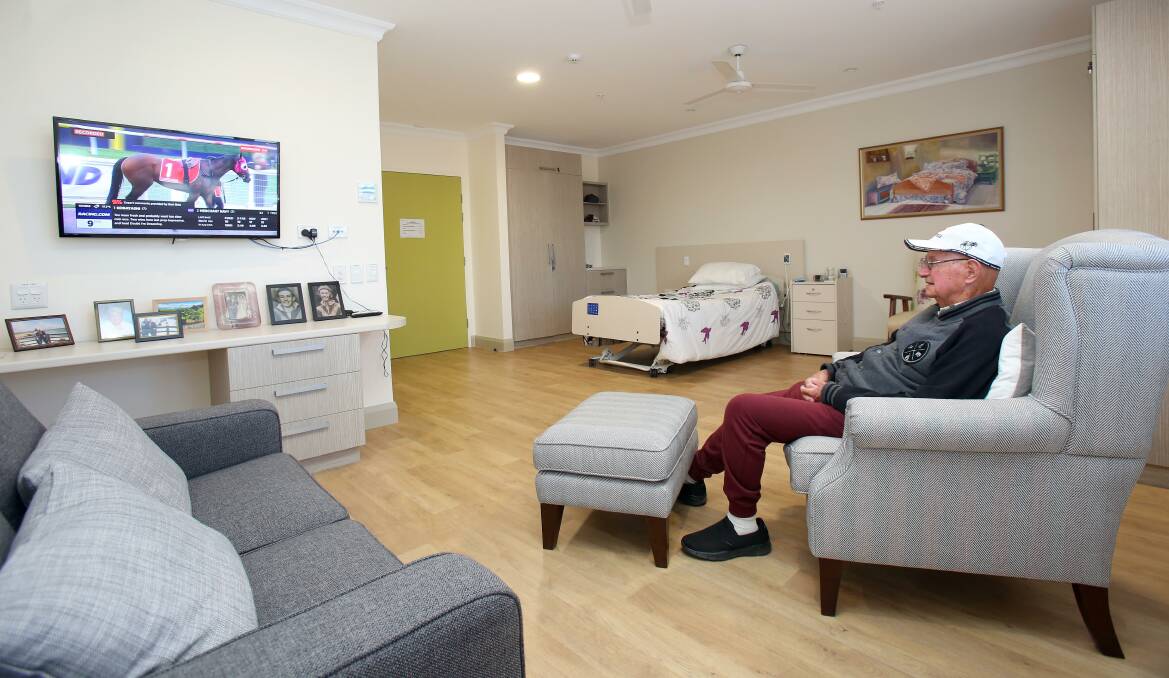 Spacious: Illawarra Diggers’ resident, Alan, watches his horse come home on one of the smart TVs in his premium suite. The generous rooms feature beautiful views, large ensuite, air conditioning and 24 hour access to care staff.