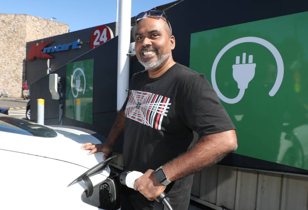 Wollongong's Naushad Ahamad charges his Tesla at a charge station in Figtree Grove. Picture by Robert Peet