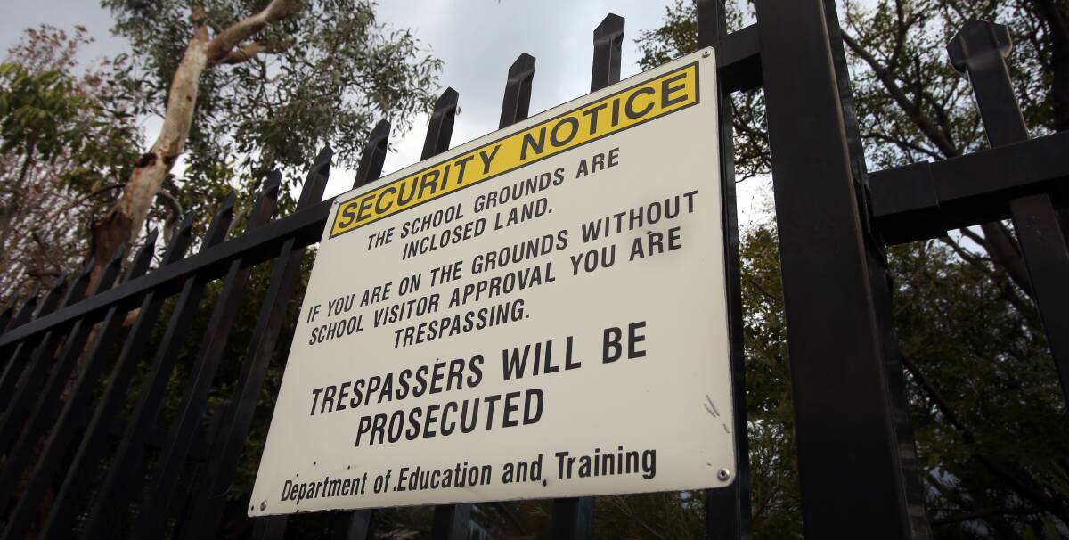 Signs at entryways to NSW schools alert visitors to their 'inclosed land' status, which gives school bosses the authority to ban visitors - including parents. File picture. 