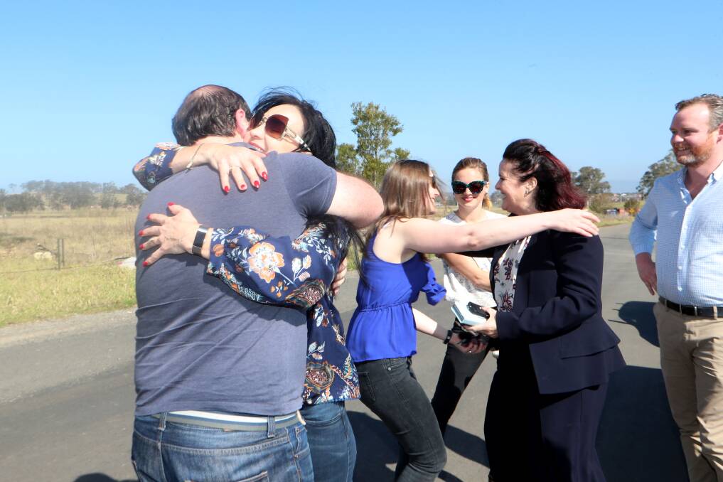 Future Wongawilli residents Alen Meza and Mary Marciano embrace at the site once earmarked for the jail, Friday afternoon. Picture: Sylvia Liber 