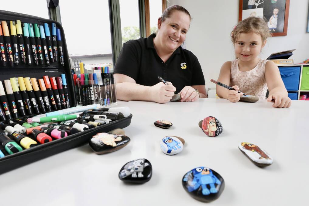 Kirrin Gruber, pictured with daughter Elena Gruber, 4, has spent countless hours hand-painting hundreds of rocks for children to find. Picture: Adam McLean