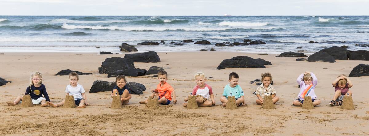 Making sandcastles: The third birthday photo took place on the sand at Towradgi. Picture: Anna Warr 