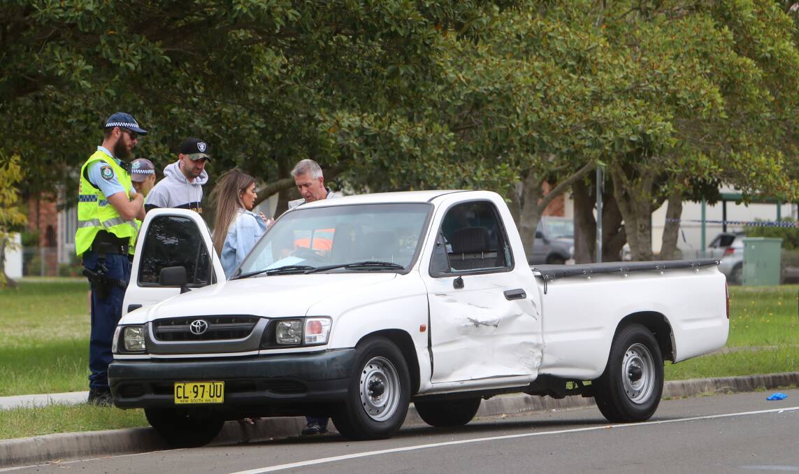 A paramedic attends to the occupants of the damaged ute. Picture: Sylvia Liber