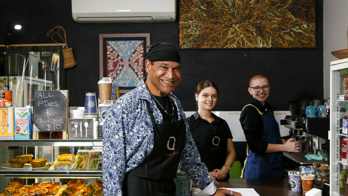 Mark Olive pictured with staff in his Brownsville cafe, Dandy's on Wodi Wodi, in June last year. 