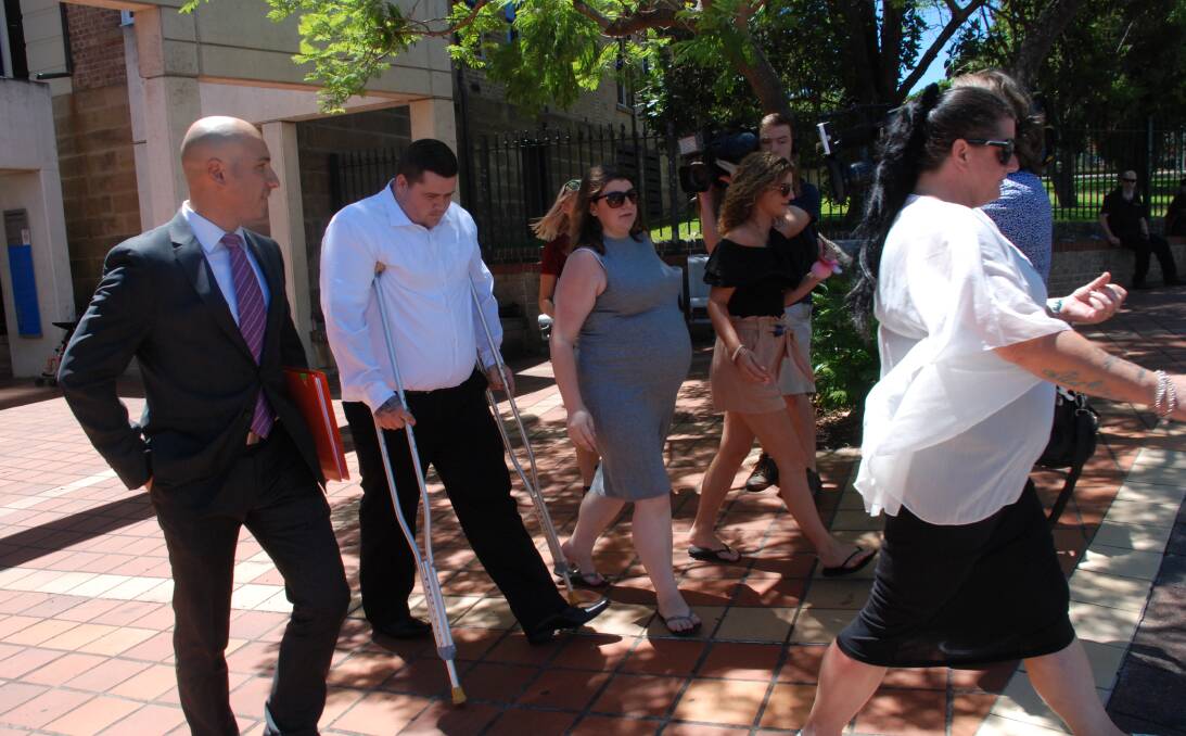 EMBARRASSED: An injured Jackson George, flanked by lawyer Ali Abbas and family members, departs Campbelltown courthouse Tuesday morning. Picture: Angela Thompson