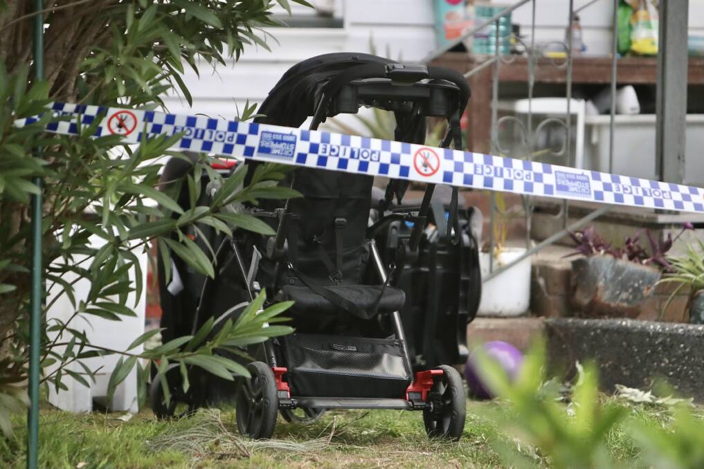 A pram is visible on the front lawn, which remains cordoned off behind police tape, Tuesday afternoon. Picture: Adam McLean 
