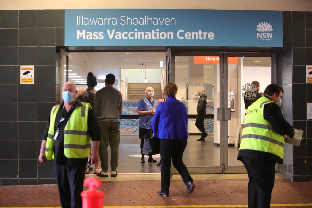 Staff flank the Globe Lane entryway to the vaccination hub in the first hours of opening on Monday morning. Picture: Sylvia Liber 