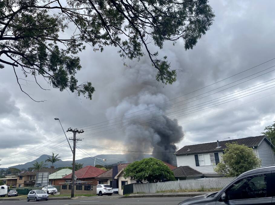 A long-lasting smoke plume is visible from the Princes Highway at West Wollongong, an hour after the fire began. Picture: Angela Thompson 