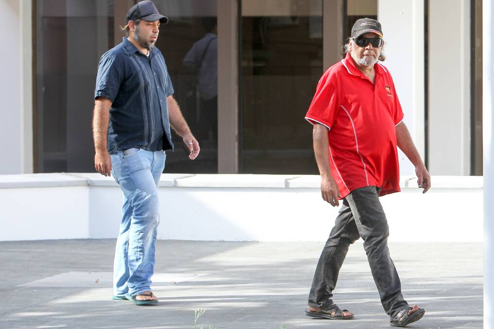 Kennedy, pictured right, arrives. A supporter carried his cap and sunglasses from the courthouse hours later, while he remained behind in the cells. Picture: Adam McLean