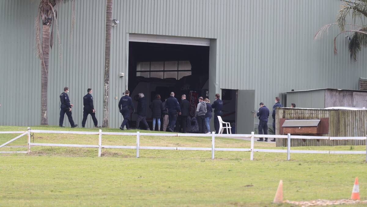 Police converge on an outbuilding at the Helensburgh property raided on Wednesday morning. Picture: Robert Peet 