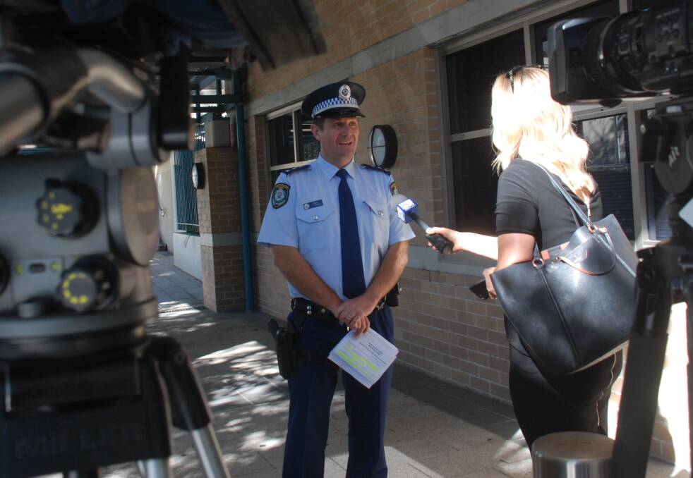 Wollongong acting inspector Dave Parker addresses reporters regarding the robberies. 