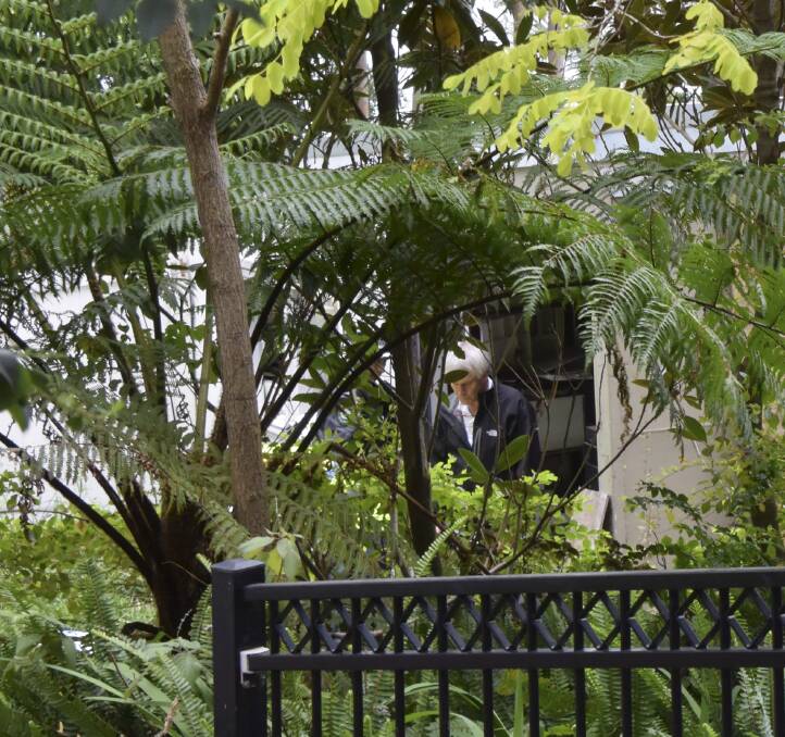 OUT OF THE OFFICE: A casually dressed Michael Lawler assists as police execute warrants at Kathy Jackson's Wombarra property on October 7. Picture: Angela Thompson