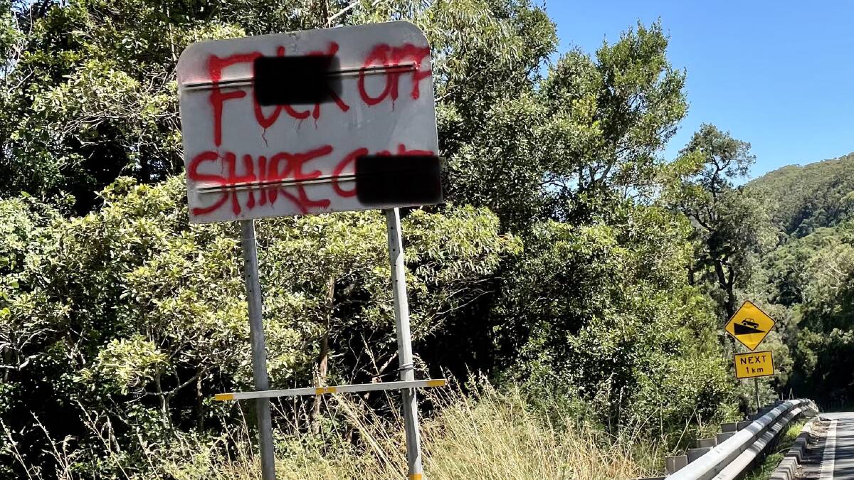 One of two messages left on signage flanking the roadway at the top of Bulli Pass on Sunday. 