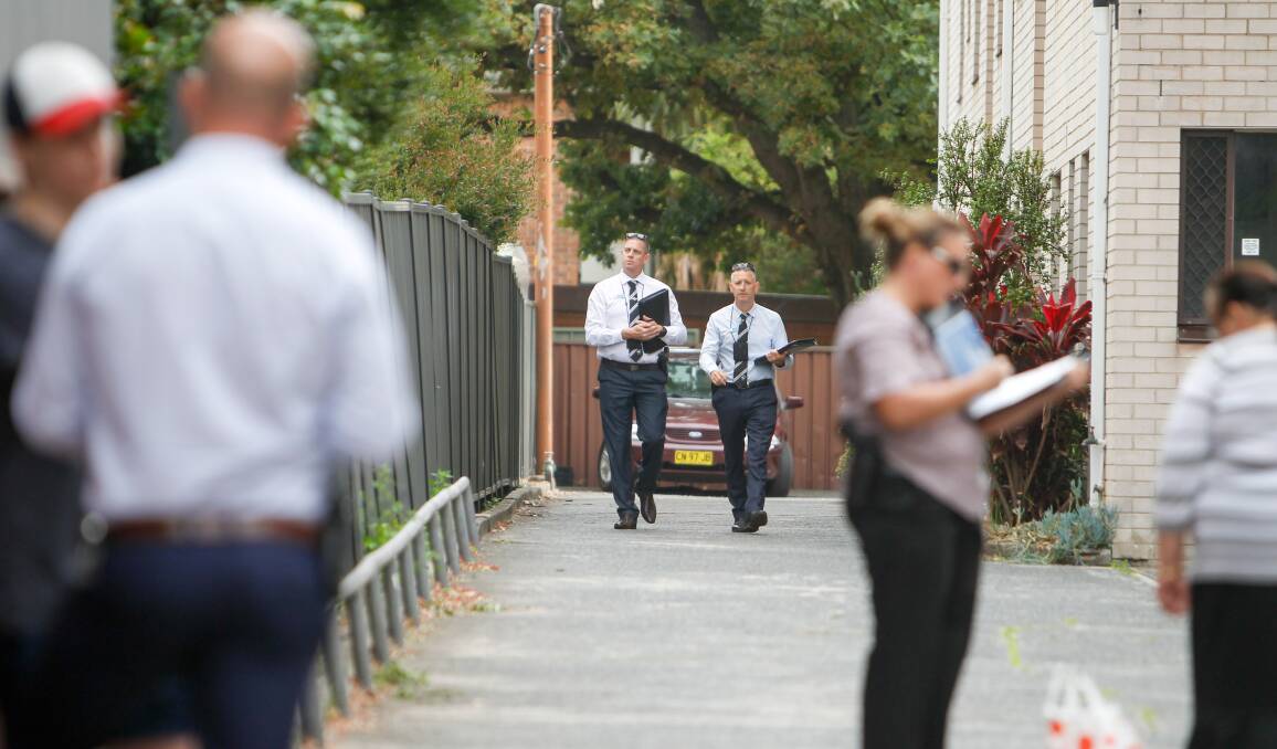Detectives at the Market Street unit complex on Wednesday morning. Picture: Adam McLean 
