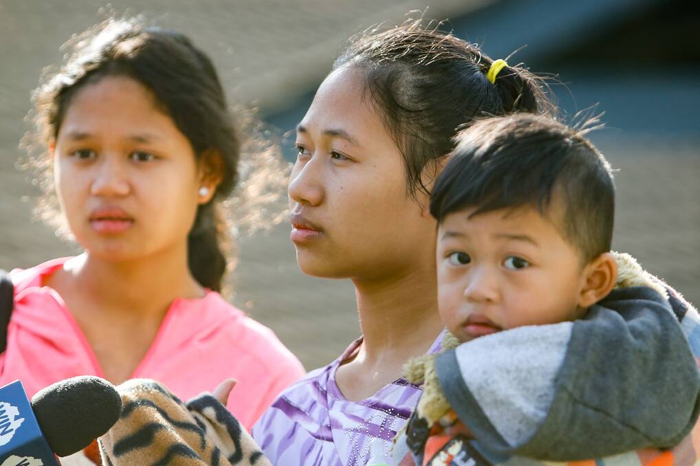 Mee Chee Htoo is flanked by her sister, Mi Kaai Aye Yee, and her two-year-old son Jack as she tells reporters about her experience. Picture: Adam McLean 