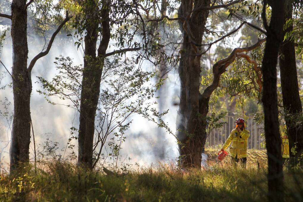 A firefighter watches over a hazard reduction burn in the Wiseman Park Reserve on May 7. Picture: Adam McLean 